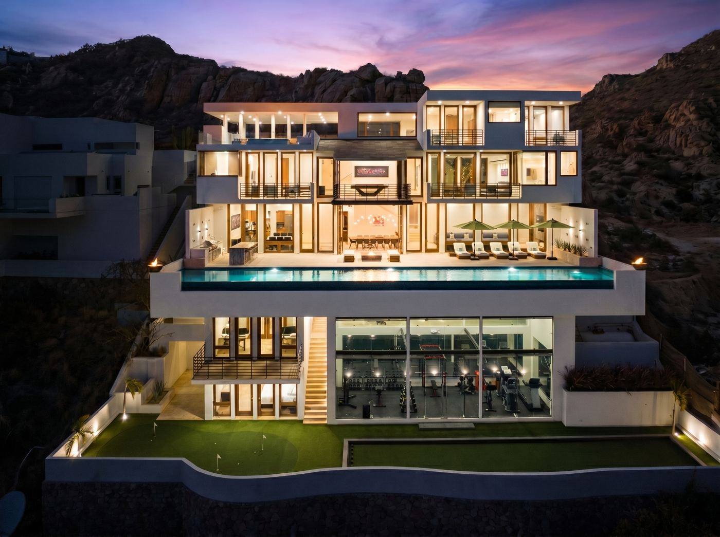 Full twilight exterior of Villa Savina showing the estate and pool