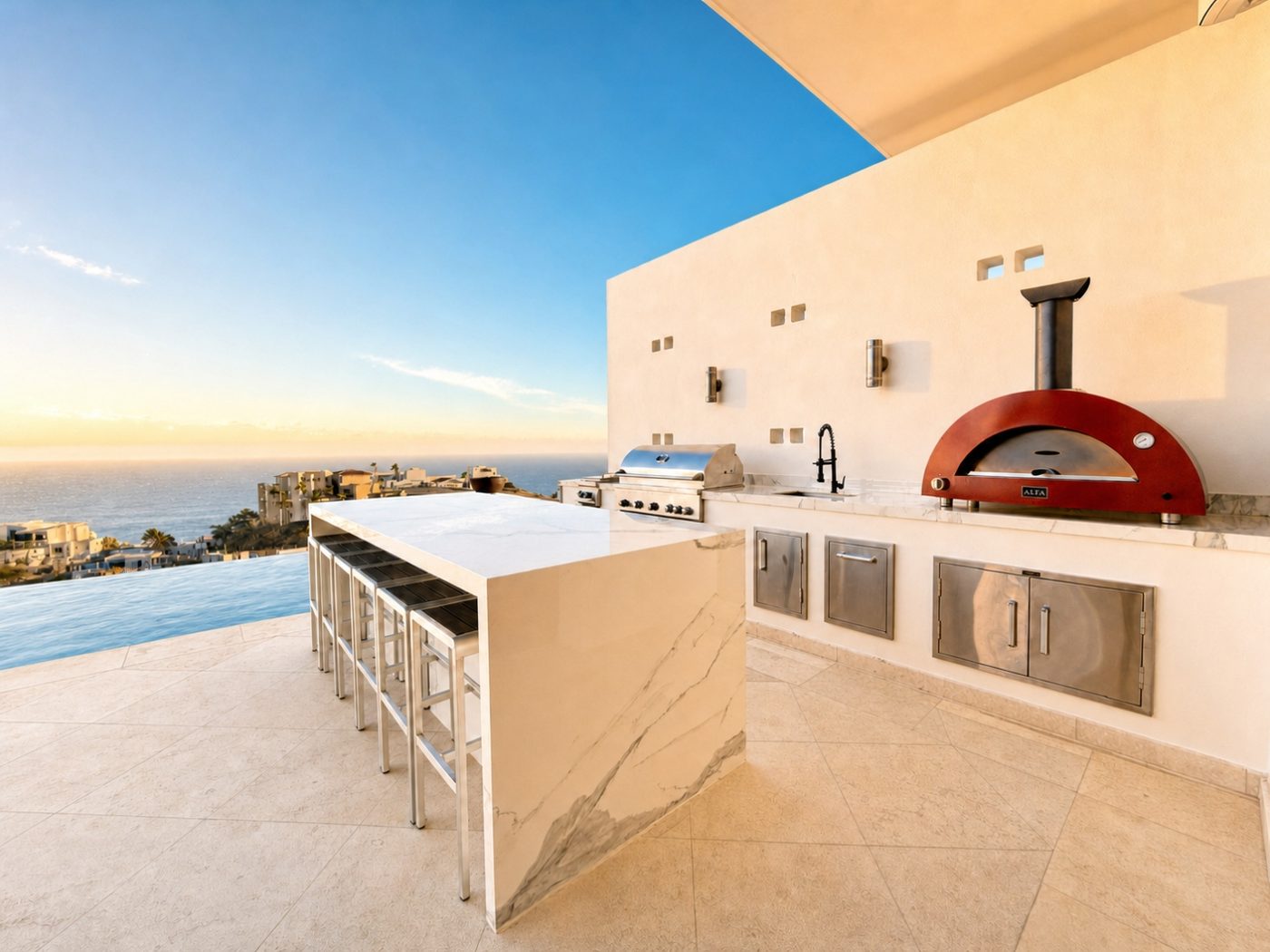 Outdoor kitchen with marble island, grill and red pizza oven