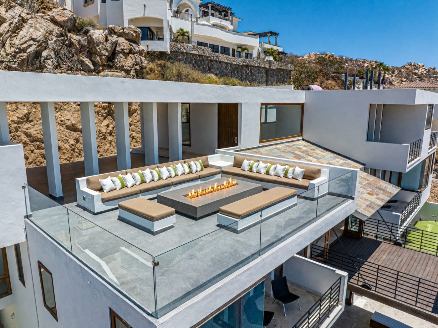 Rooftop fire lounge with linear fire feature and U-shaped seating