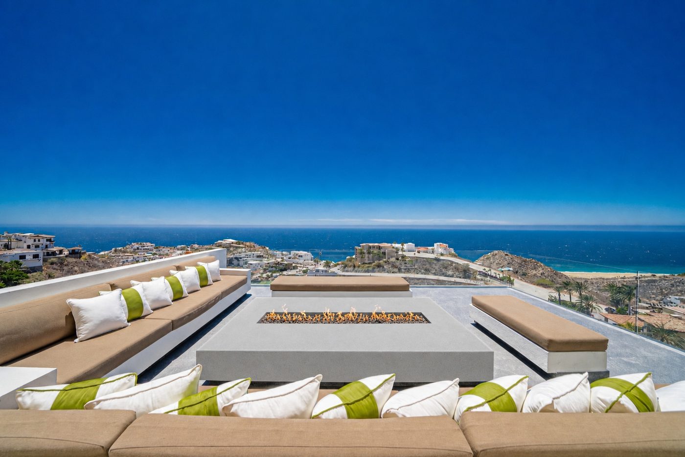 Wide view of rooftop fire pit terrace and Cabo coastline