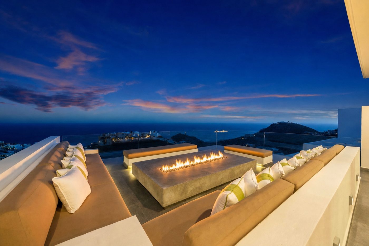 Rooftop fire pit lounge at sunset overlooking the bay