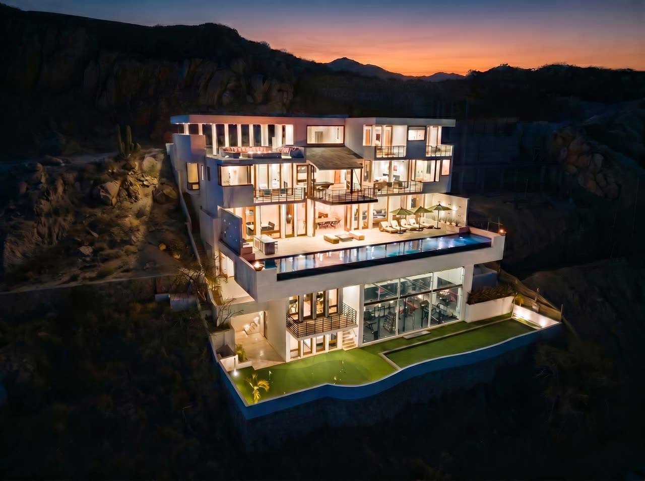Villa Savina at twilight, lit across all five levels above the Pedregal cliffside